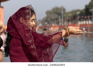 young devotee praying for holy god after bathing in holy river water at morning from flat angle