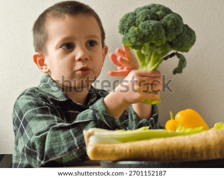 The young dietitian does a quality control check, tasting a piece of fresh broccoli