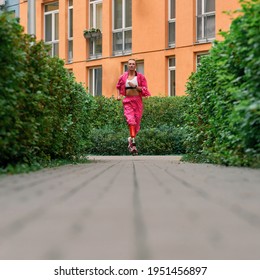 Young Disabled Athlete Woman With Prosthetic Leg In Sportswear Running Outdoor. Paralympic Sport Concept