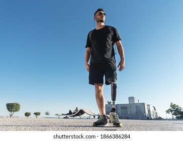 Young disabled man with prosthetic leg outdoors, low angle shoot. - Powered by Shutterstock