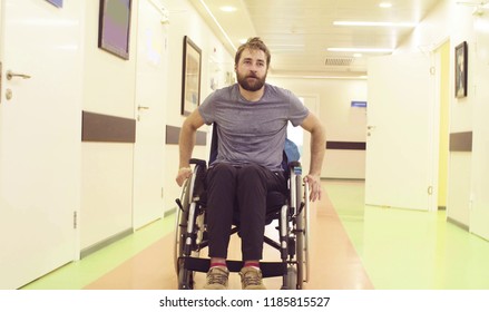 Young disabled man in a wheelchair riding in the rehabilitation center