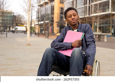 young disabled student sitting in a wheelchair  holding folders