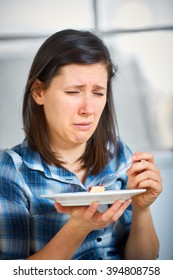Young disgust female after trying piece of cake, healthy diet concept, avoid sugar