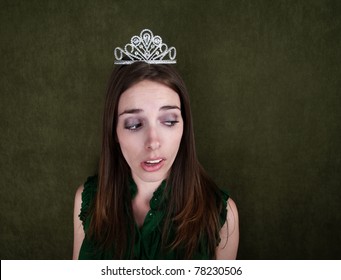 Young Disinterested Homecoming Queen On Green Background