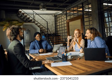 Young and diverse group of designers having a meeting in an office while working in a startup company - Powered by Shutterstock