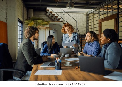 Young and diverse group of designers having a meeting in an office while working in a startup company - Powered by Shutterstock