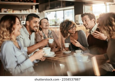 Young and diverse group of people talking and having coffee together in a cafe - Powered by Shutterstock