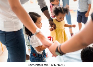 Young diverse kids standing with their parents - Shutterstock ID 1247716711