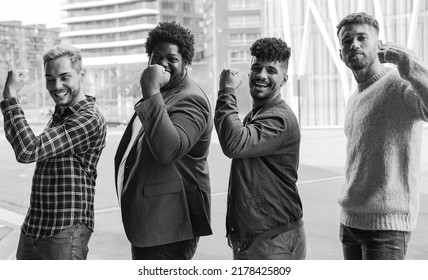 Young Diverse Male Friends Showing Muslce Biceps In The City