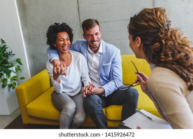 Young Diverse Married Couple Talking To Their Agent, Advisor,therapist Or Sales Representative