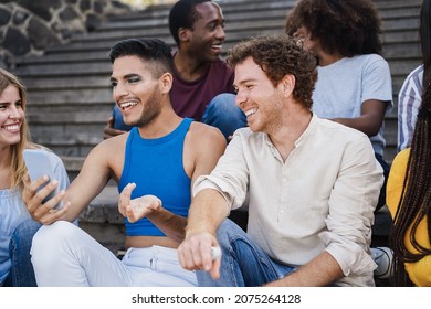 Young diverse people having fun outdoor laughing together - Focus on right man face - Powered by Shutterstock