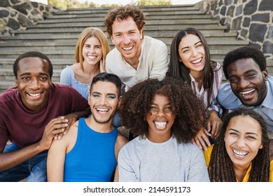 Young diverse people having fun outdoor laughing together - Focus on center african girl face - Powered by Shutterstock