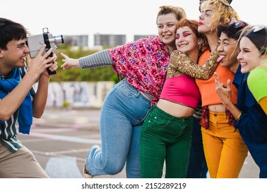 Young Diverse People Having Fun With Old Vintage Video Camera Outdoor - Focus On Girl With Eye Shadow