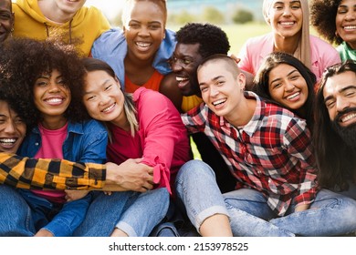 Young diverse people having fun outdoor laughing together - Diversity concept - Main focus on bald girl face - Powered by Shutterstock