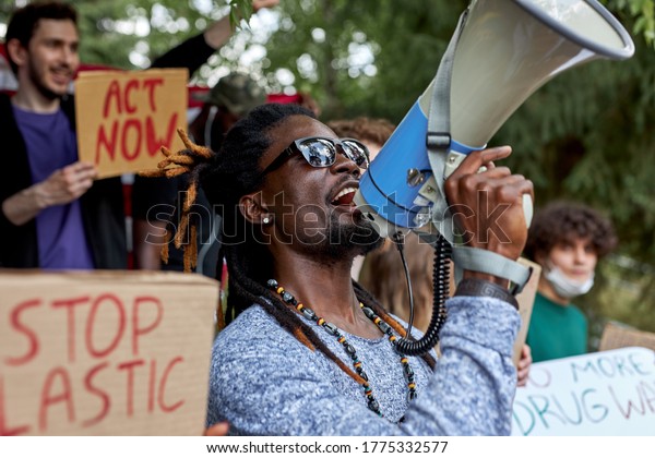 young diverse people protest with placards and\
posters on global strike for climate change. save our planet from\
plastic pollution