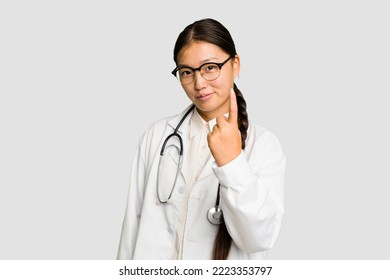 Young Doctor Asian Woman Isolated Pointing With Finger At You As If Inviting Come Closer.