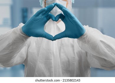 Young Doctor Cardiologist Showing Heart Symbol With Fingers, Expressing Love And Support To Patients, Healthcare Medical Donation Concept.