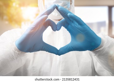 Young Doctor Cardiologist Showing Heart Symbol With Fingers, Expressing Love And Support To Patients, Healthcare Medical Donation Concept.