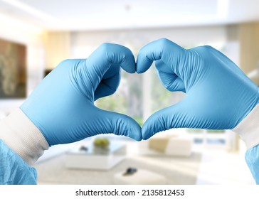 Young Doctor Cardiologist Showing Heart Symbol With Fingers, Expressing Love And Support To Patients, Healthcare Medical Donation Concept.