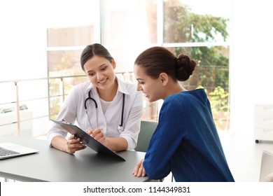 Young doctor consulting patient in modern hospital