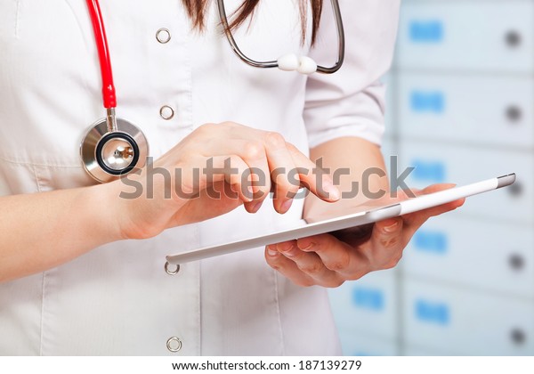 young doctor with digital\
tablet