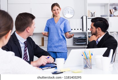 Young Doctor Giving Lecture For Businessmen In Office On Providing First Aid 