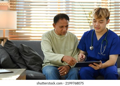 Young Doctor Holding Digital Tablet And Giving Healthcare Medical Advices To Senior Male Patient