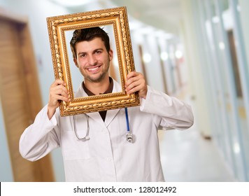 Young Doctor Holding Frame, Indoor