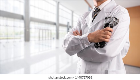 young doctor with hospital background