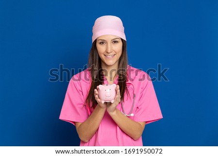 Young doctor with a pink uniform on a blue background