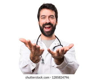 Young doctor presenting something on white background