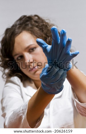 young doctor putting on gloves