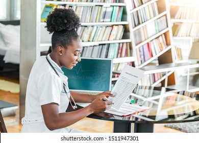 Young doctor with stethoscope in her doctor's office calculating medical bills. Healthcare costs and fees concept. Medical costs in modern hospital