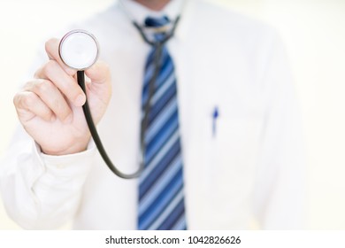 Young doctor with the stethoscope on his hand