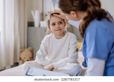 Young doctor taking care of little girl in hospital room. - Powered by Shutterstock