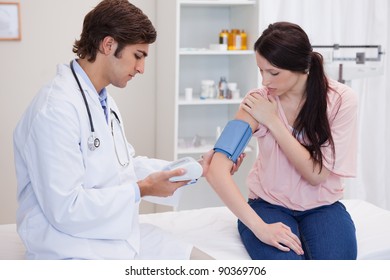 Young Doctor Taking Patients Blood Pressure