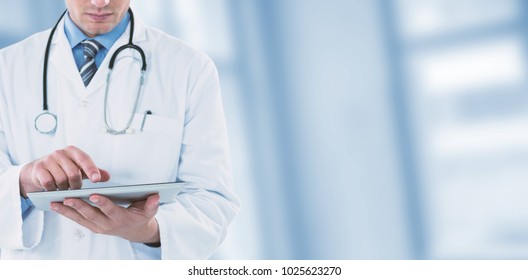 Young doctor using digital tablet against dental equipment - Shutterstock ID 1025623270