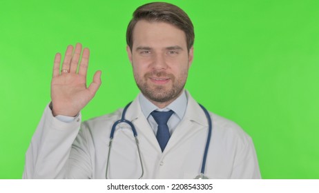 Young Doctor Waving Hand To Say Hello On White Background