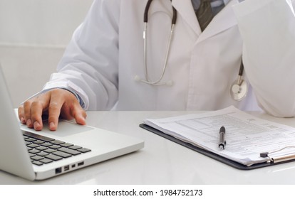 A young doctor who is worried about his medical career at work. with laptop notebook A highly thoughtful male therapist is worried about solving drug problems.