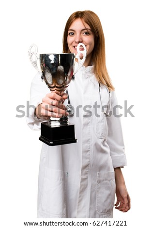Young doctor woman holding a trophy