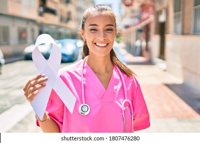 Young Doctor Woman Holding White Cancer Ribbon Walking At Street Of City.