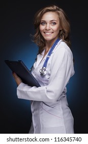 Young Doctor Woman With Stethoscope On Dark Blue Background