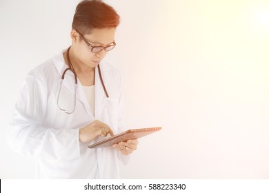 Young Doctor Working With Ipad In Hand. Technology Of Health Care On Line