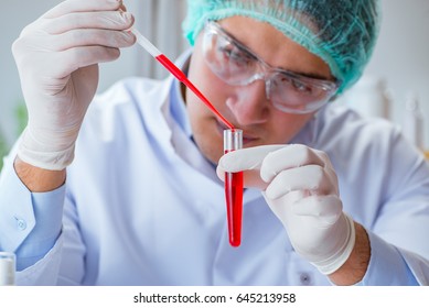 Young doctor working on blood test in lab hospital - Shutterstock ID 645213958