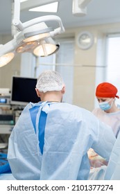 Young Doctors Surgeon In Mask In Modern Hospital. Healthcare Surgery Worker In New Clinic. Stock Photo