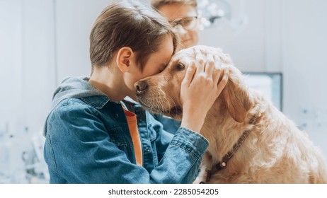 Young Dog Owner Happy to See His Pet Golden Retriever Alive and Well After a Medical Procedure at a Modern Veterinary Clinic by Professional Veterinarian. Boy Petting and Bonding with the Dog - Powered by Shutterstock