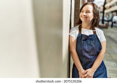 Young Down Syndrome Woman Smiling Confident Wearing Apron At Street