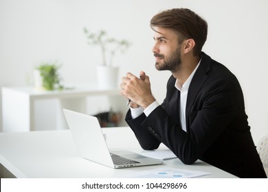 Young Dreamy Businessman In Suit Thinking Of Business Vision Outlook Planning Future Project Idea At Work With Laptop, Successful Happy Contemplative Entrepreneur Dreaming Of New Opportunity Prospect