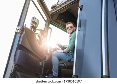 Young driver in cabin of big truck - Shutterstock ID 1938518197