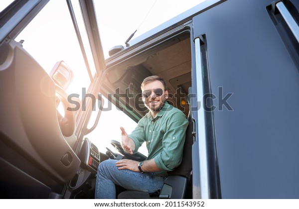 Young driver in cabin of big\
truck